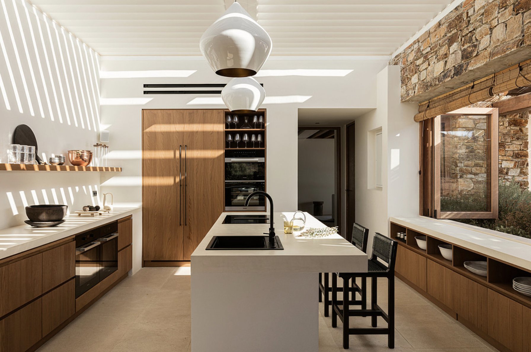 Kitchen with stone feature wall and island