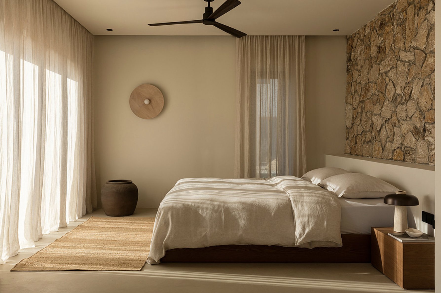 Primary bedroom with stone feature wall