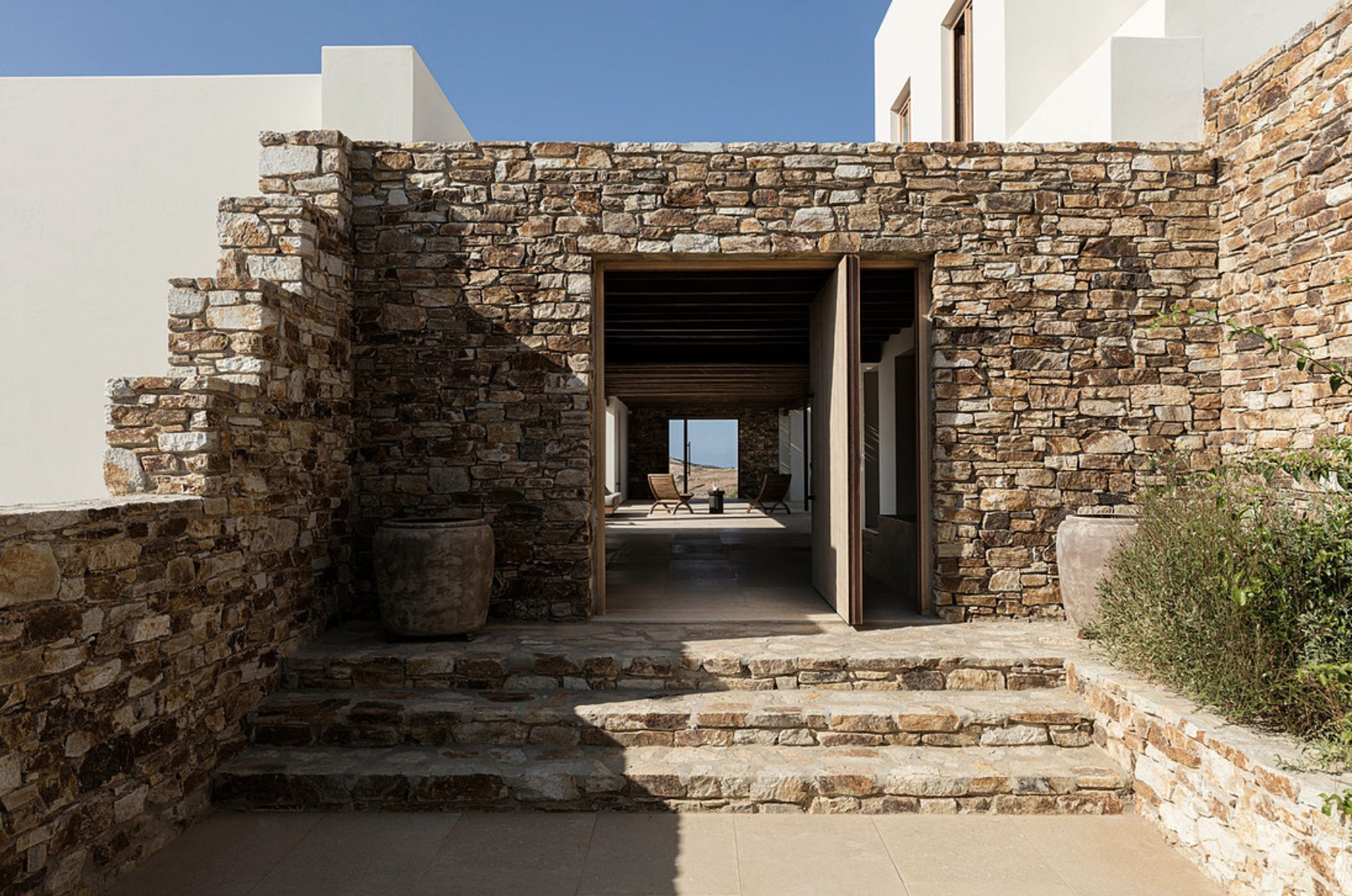 Stone entrance corridor framing a view to the sea